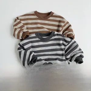 Detail view of retro striped crewneck sweatshirts for kids in brown and gray colors