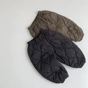 Close-up of quilted children pants showing elastic waist and thick thermal fabric