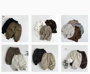 Flat lay of diverse winter children's outfits showing fabrics and matching styles