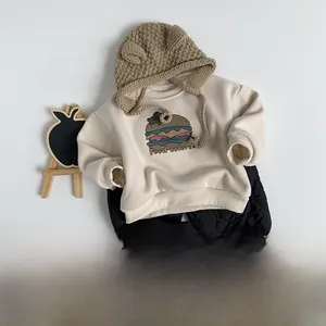 Flat lay of cream toddler sweatshirt with burger print and quilted joggers set
