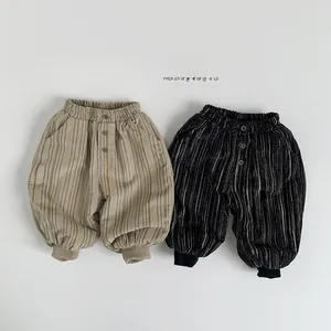Detail of children's corduroy joggers with elastic waistband and striped pattern