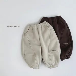 Detail view of fleece joggers with STUDY HARD print and curved stitching details