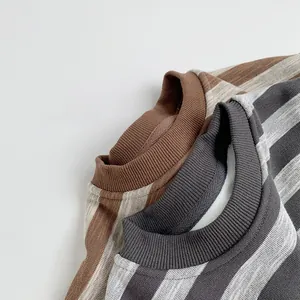 Detail of soft ribbed knit texture on striped long sleeve sweaters for children