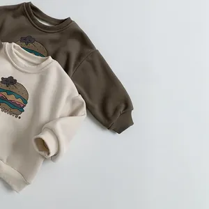 Detail view of ribbed necklines and retro burger prints on kids fleece sweatshirts