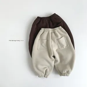 Detail view of fleece-lined warm jogger pants for kids in brown and beige colors
