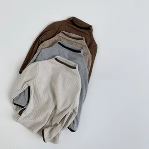 Detail view of four-color kids ribbed knit sweaters with contrast trim edging