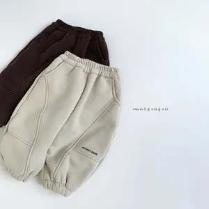 Detail view of fleece-lined warm joggers for kids in dark brown and oatmeal colors