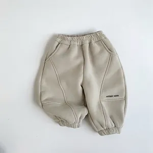Detail of children's thick fleece jogger pants with elastic waist and study hard print