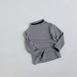 Close-up of kids ribbed knit sweater featuring grey fabric and black contrast trim