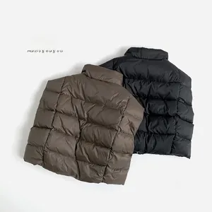 Detail of brown and black puffer vests with stand-up collar and horizontal quilting