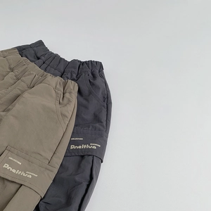 Dettaglio di pantaloncini cargo per bambini kaki e grigi con vita elastica e tasche
