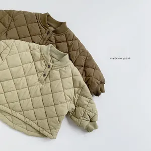 Detail view of children's diamond quilted cotton sweatshirts in brown and khaki