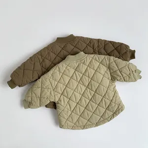 Detailed view of diamond quilted children sweatshirts in brown and beige colors
