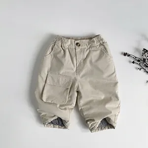 Detail view of warm khaki cargo pants with elastic waist and grey thick lining