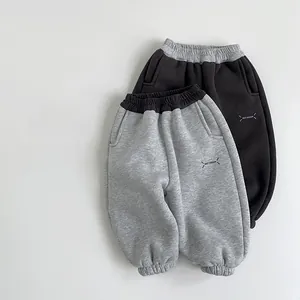 Detail of color-blocked kids joggers in black and grey with Best Dream logo print