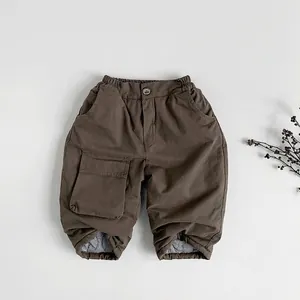 Detailed view of kids warm cotton winter trousers with thick fleece lining and cargo pockets