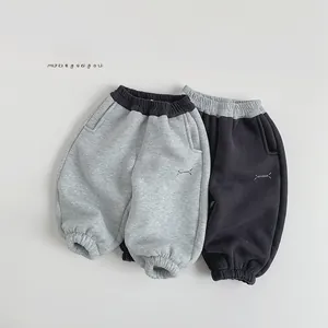 Detail of fleece-lined kids sweatpants with elastic waist and JUST DREAM print