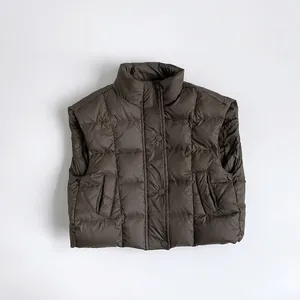 Detailed view of kids dark brown puffer vest featuring square quilting and stand collar