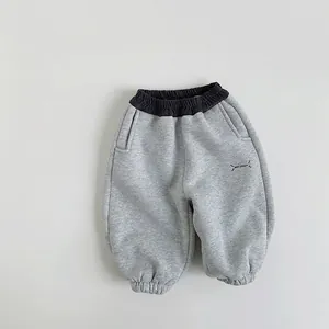 Close-up of gray kids joggers with Best Dream print and elastic contrast waistband