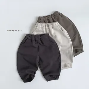 Flat lay of knit kids shorts in dark grey, beige, and brown with elastic waist and pockets
