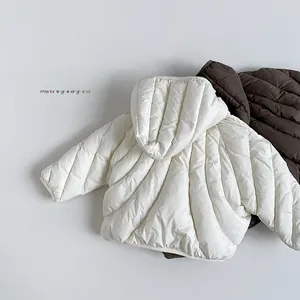 Close-up of lightweight quilted kids puffer jacket showing diagonal stitching and soft textures