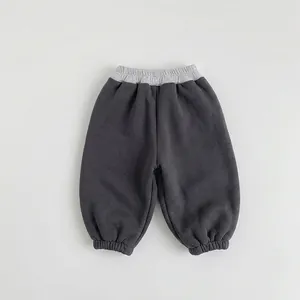 Detailed close-up of dark grey kids joggers featuring a contrast light grey ribbed waistband