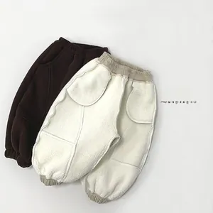 Detailed macro view of warm fleece-lined winter sweatpants for children in brown and beige