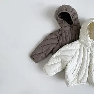 Detail of diagonal quilted kids down jacket with hood and zipper closure for winter