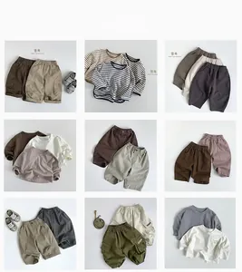 Flat lay of multiple color-block kids outfits with striped tees and cargo pants