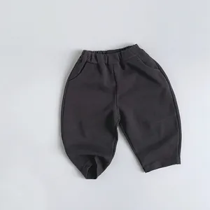 Detail of dark grey kids knitted joggers with elastic waist and side pockets