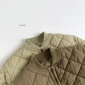 Detailed close-up of quilted cotton jackets showing ribbed collars and button closure