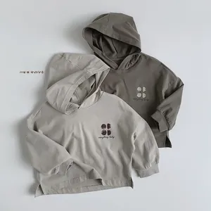 Close-up of kids hooded sweatshirt with lucky print and side slit hem detail