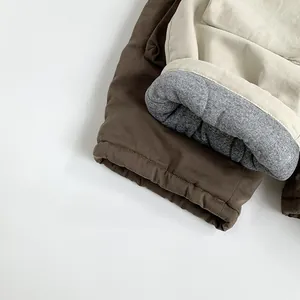 Detail of warm winter trousers showing the quilted grey lining and thick fleece padding