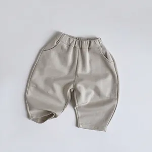 Detail of kids knit joggers featuring an elastic waistband and curved side pockets