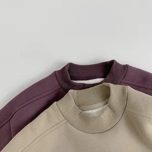Detail of ribbed neckline and thick white fleece lining on children's winter sweatshirts