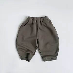 Detail view of children's knit pants featuring elastic waistband and side slit pockets