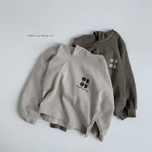 Close-up of kids hooded sweatshirts in beige and coffee with everything lucky text