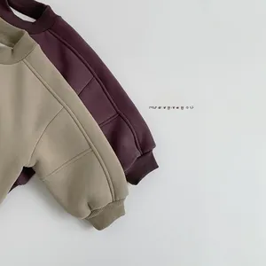 Detail view of ribbed round neck and cuffs on thick fleece sweatshirts for kids