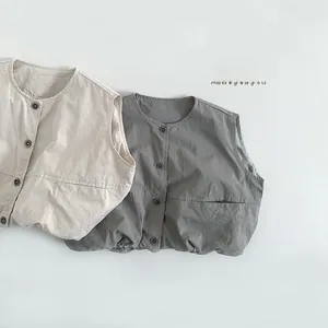 Flat lay detail of beige and dark grey cotton vests for kids with button-up design