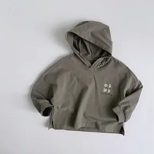 Close-up of kids hooded sweatshirt with lucky text print and split side hem detail