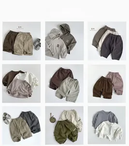Flat lay grid showing nine Korean style cotton hoodie and cargo pants sets for kids