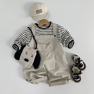 Kids casual outfit with striped shirt, khaki overalls, matching cap and puppy bag