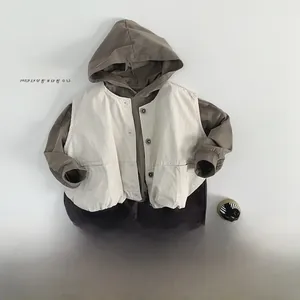 Flat lay of kids 3-piece set with brown hoodie, beige vest, and casual cotton pants