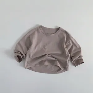 Detail of greyish-purple long sleeve cotton kids T-shirt with curved hem and soft texture