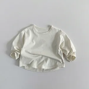 Detailed flat lay of cream-colored kids long sleeve t-shirt with soft cotton texture