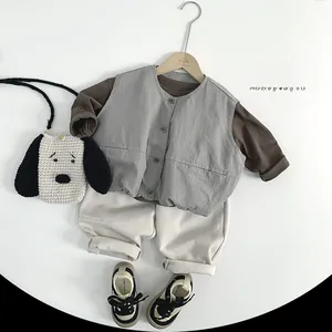 Detail of children outfit with grey vest brown shirt and dog crochet bag set