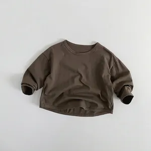 Detail view of children's long-sleeved t-shirt in deep brown with a soft cotton texture