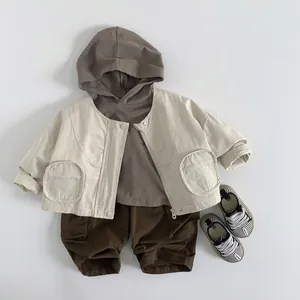 Three-piece minimalist kids spring outfit with beige jacket, brown hoodie and cargo shorts