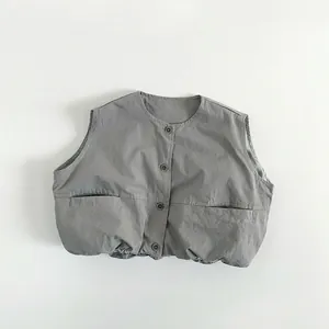 Detailed view of gray kids vest featuring four buttons and large front pockets