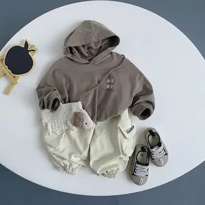 Kids Korean style brown hoodie with beige cargo pants and puppy bag flat lay outfit